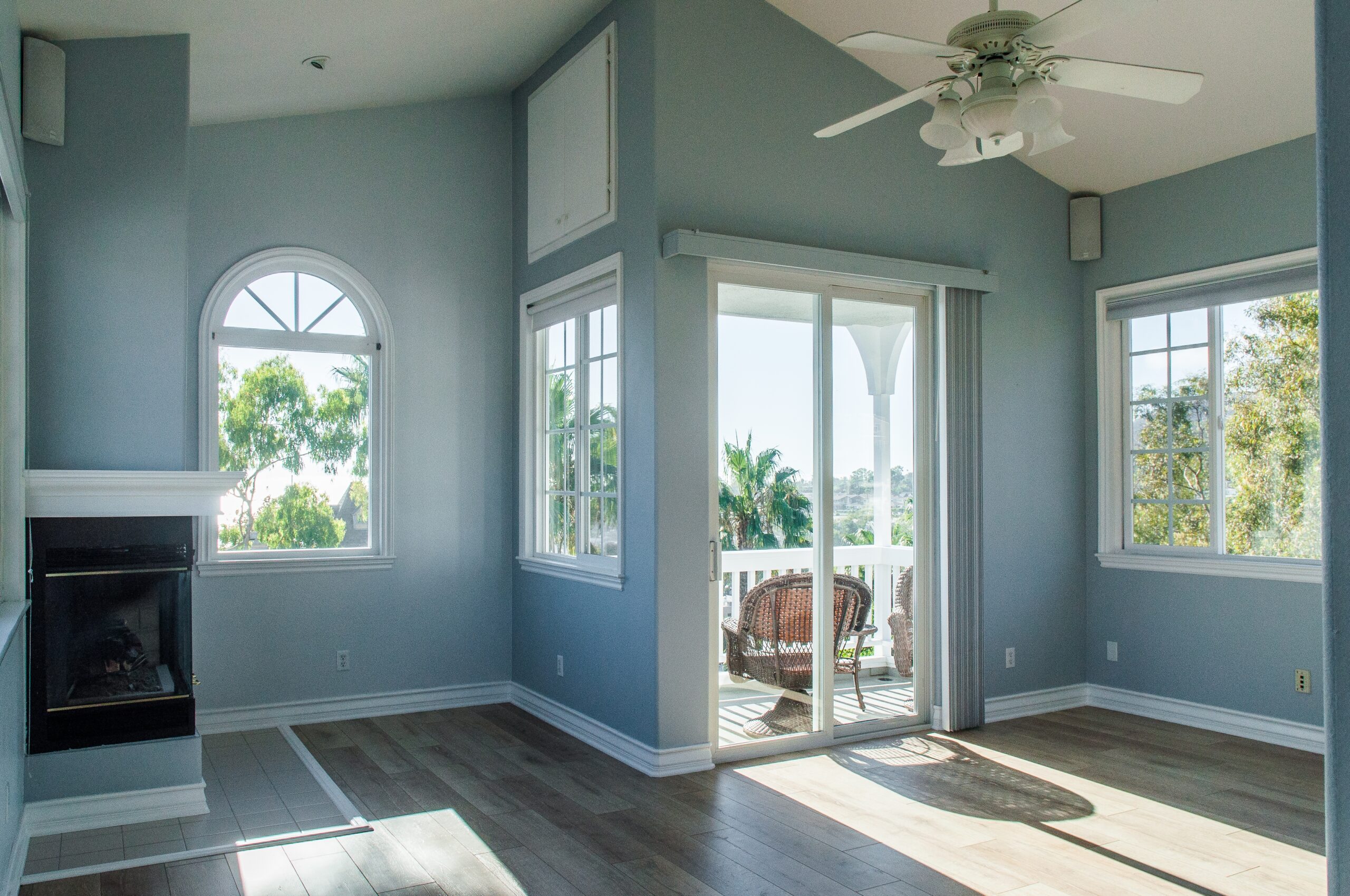 trendy modern interior of a living room with blue walls and white windows